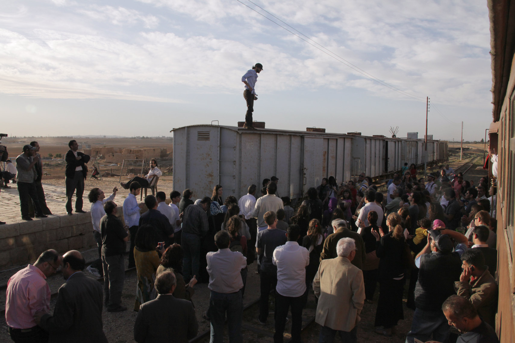 Syrian poet Ayham Agha performs on top of trains in Giza.